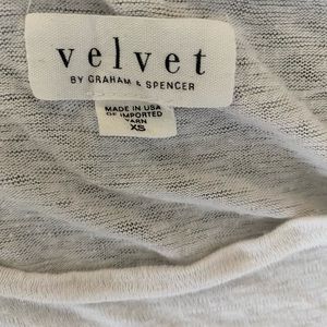 White tank top with ruffle sides.